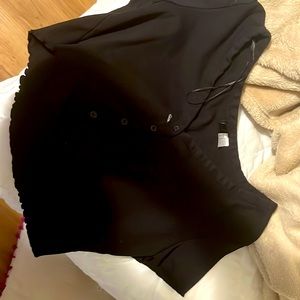 it has ruffles on the sleeves and bottom half with a low cut neck